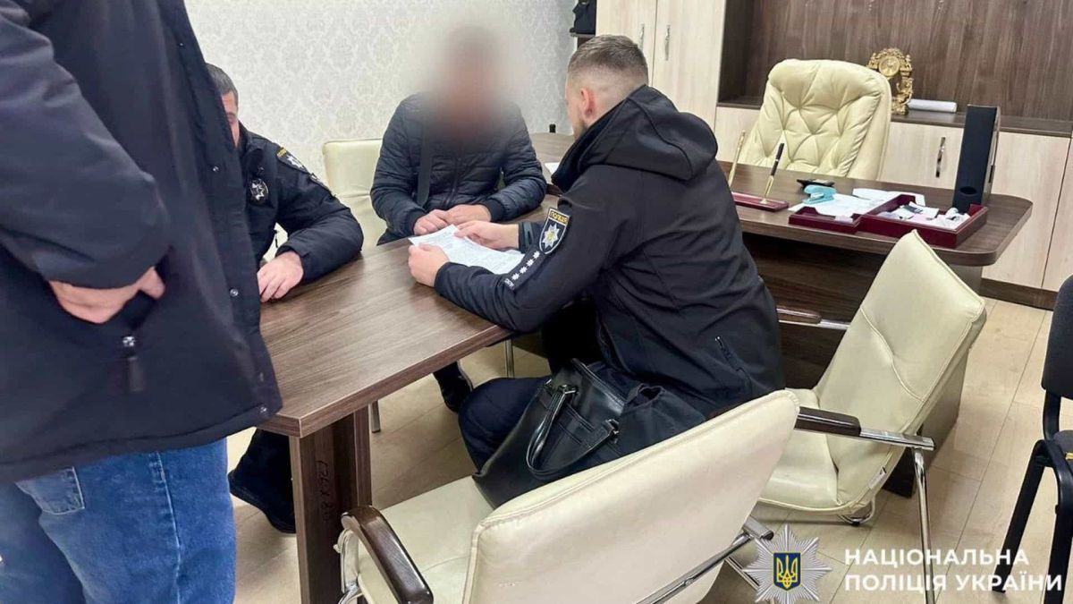 У Білій Церкві забудовник продав квартиру двічі: вручили підозру Правоохоронці сидять за столом в офісі поряд із підозрюваним у скоєнні злочину