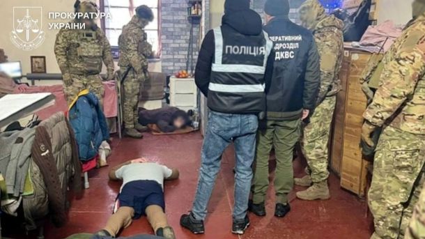 Киянина затримали за шантаж публічної особи Правоохоронці та двоє цивільних осіб, які лежать обличчями до підлоги