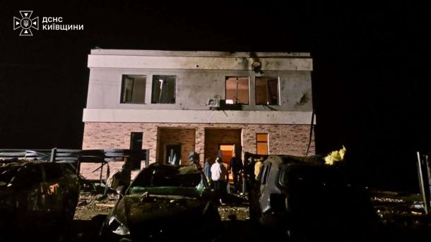 Пожежа у Дніпровському р-ні: вогонь охопив два авто після атаки Пошкоджений фасад двоповерхового будинку з вибитими вікнами та розбиті автомобілі після удару безпілотника в Бучанському районі