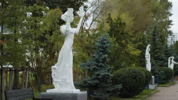 Головні новини Києва | Kyiv.News Біла мармурова скульптура жінки в довгій сукні, що стоїть у парку серед зелених дерев
