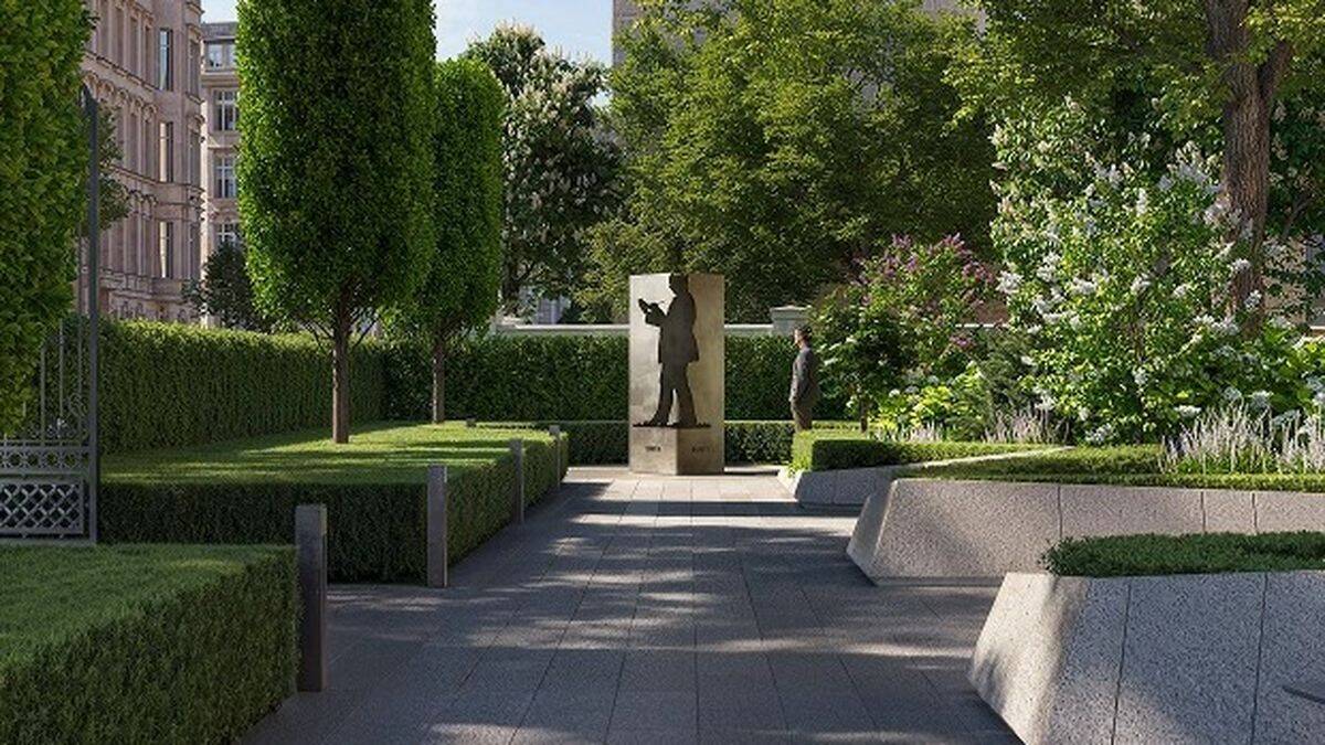 Зелені дерева і кущі біля пам’ятника у парку Києва, м'яке світло і тіні, сучасна архітектура, спокійна атмостфера, міська зелень, центральна частина міста, комфортне місце для відпочинку.