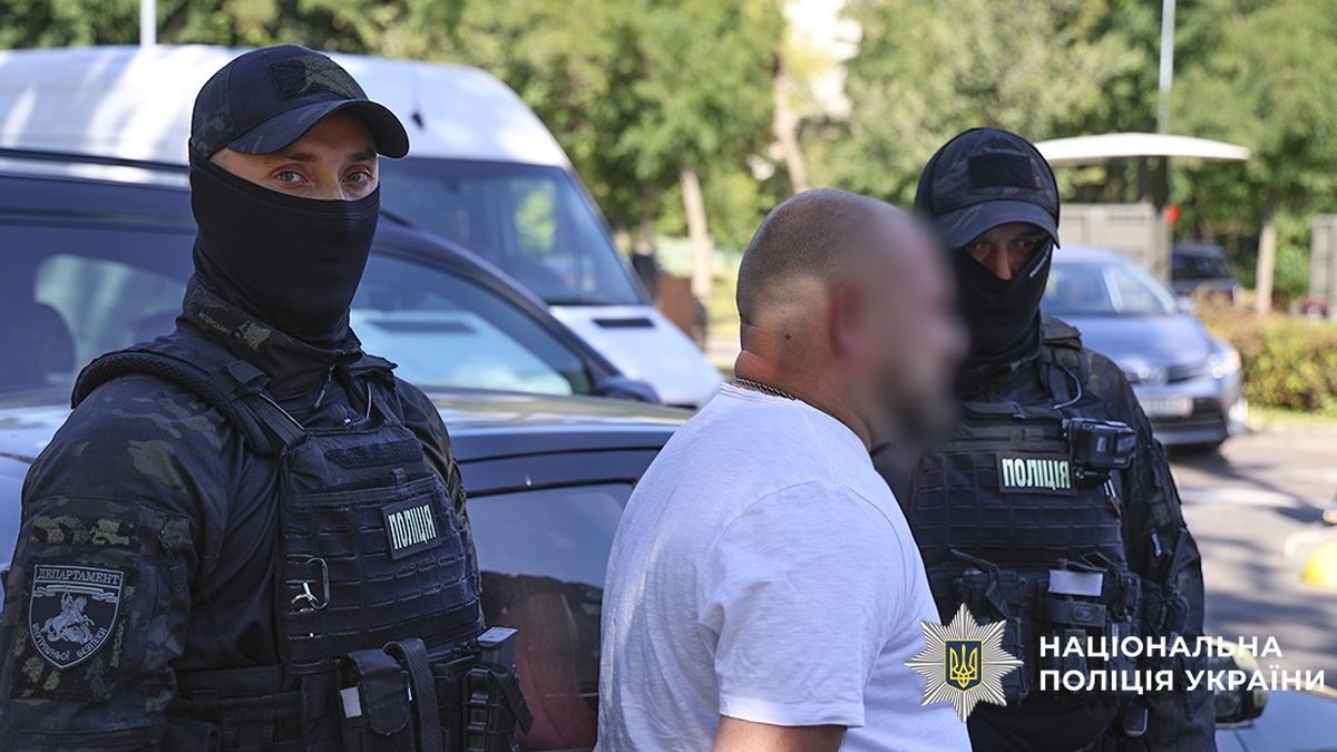 Затримання підозрюваного поліцією Києва біля автівки на вулиці в місті. Поліцейські у тактичній екіпіровці забезпечують безпеку під час операції.