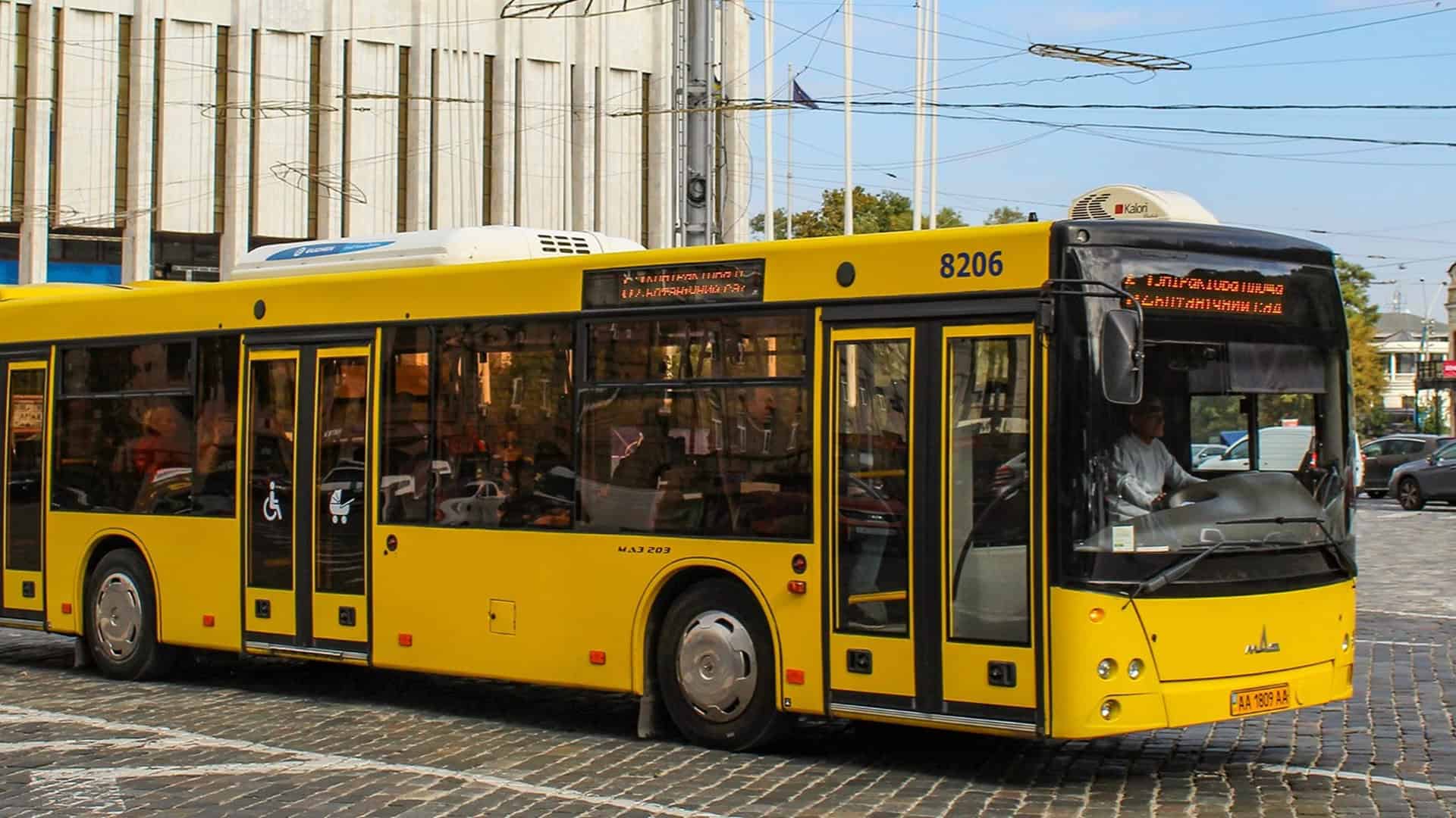 Жовтий автобус їде вулицею Києва