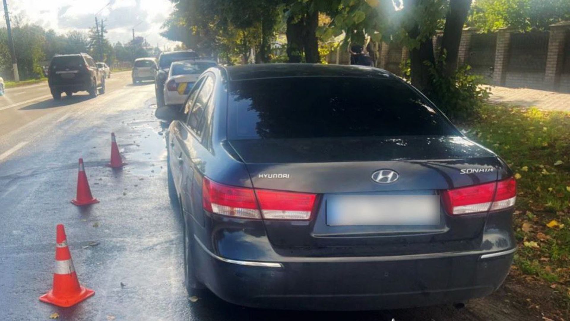 Темний автомобіль Hyundai Sonata припаркований на узбіччі дороги