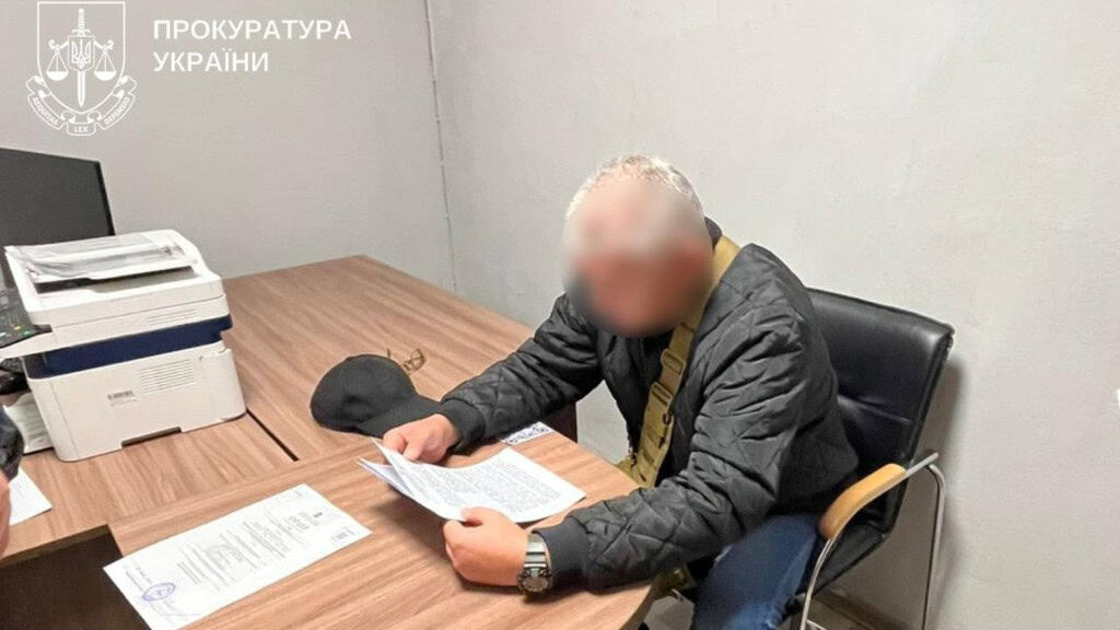 У Києві розікрали 550 тисяч грн на ремонті школи Чоловік в чорній куртці сидить за столом в кабінеті і читає папери, обличчя в нього заблюрене, ймовірно він - підозрюваний у справі