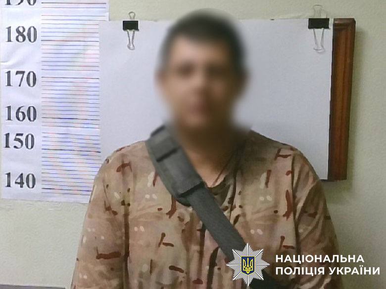 Підозрюваний у скоєнні злочину стоїть біля стіни в поліції