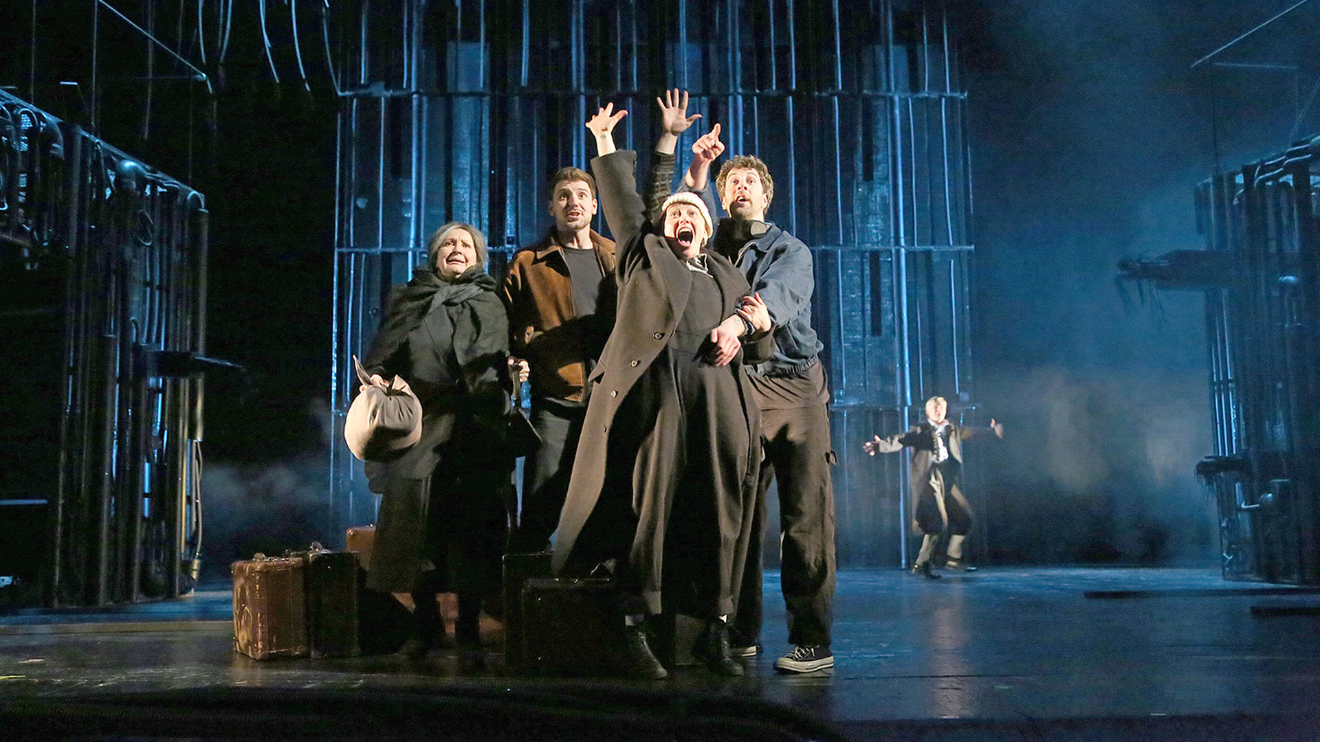 Люди в темному одязі на сцені театру