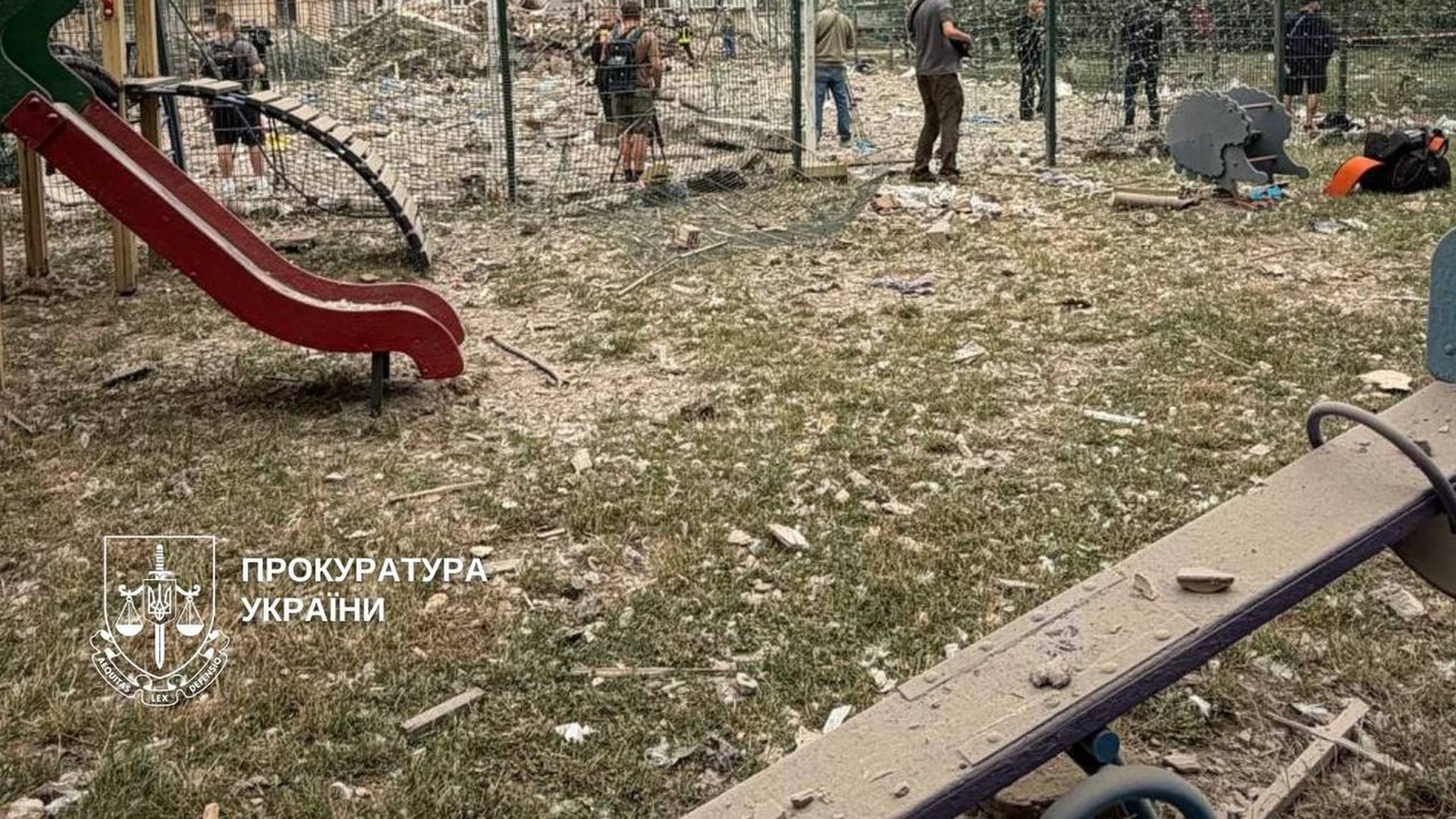 Оболонський проспект: гаряча вода повернулась у 3 будинки Дитячий майданчик з гіркою на тлі частково зруйнованого багатоповерхового будинку, працюють слідчі