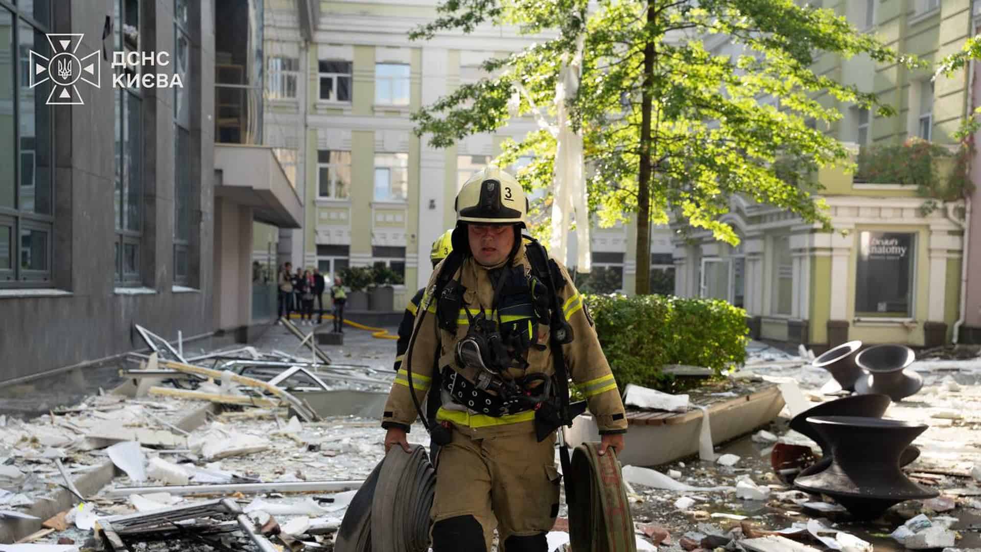 Рятувальник ДСНС Києва несе пожежні рукави серед уламків і розбитих конструкцій після російської атаки 23 вересня 2026