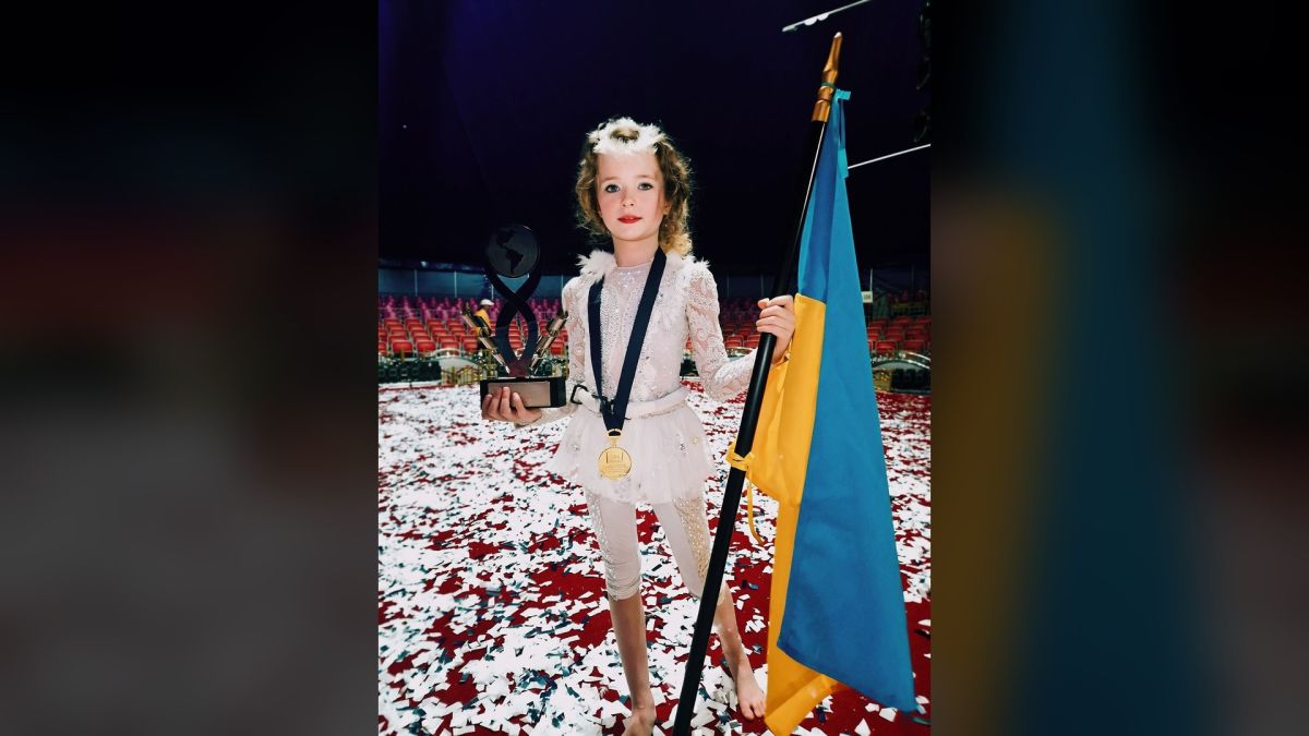 Восьмирічна циркова артистка Анастасія Горбацевич з трофеєм і прапором України після здобуття срібної нагороди на фестивалі в Перу.