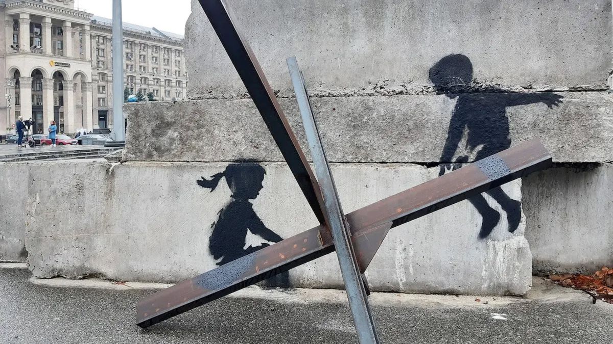 Мурал Бенксі на бетонному блоці на Майдані Незалежності в Києві — двоє дітей на гойдалці
