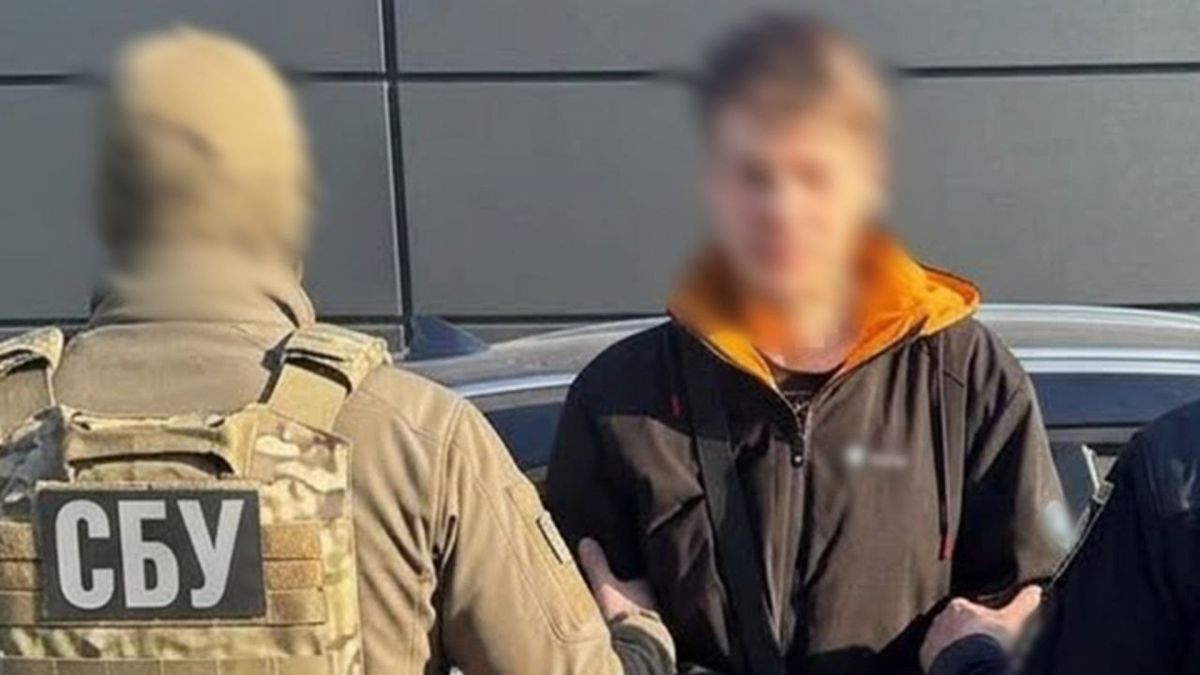 Підпали авто на замовлення РФ: СБУ затримала п’ятьох, серед них — з Білої Церкви Співробітник СБУ тримає затриманого із заблюреним обличчям біля автомобіля — підозрюваного в підпалі авто на замовлення РФ