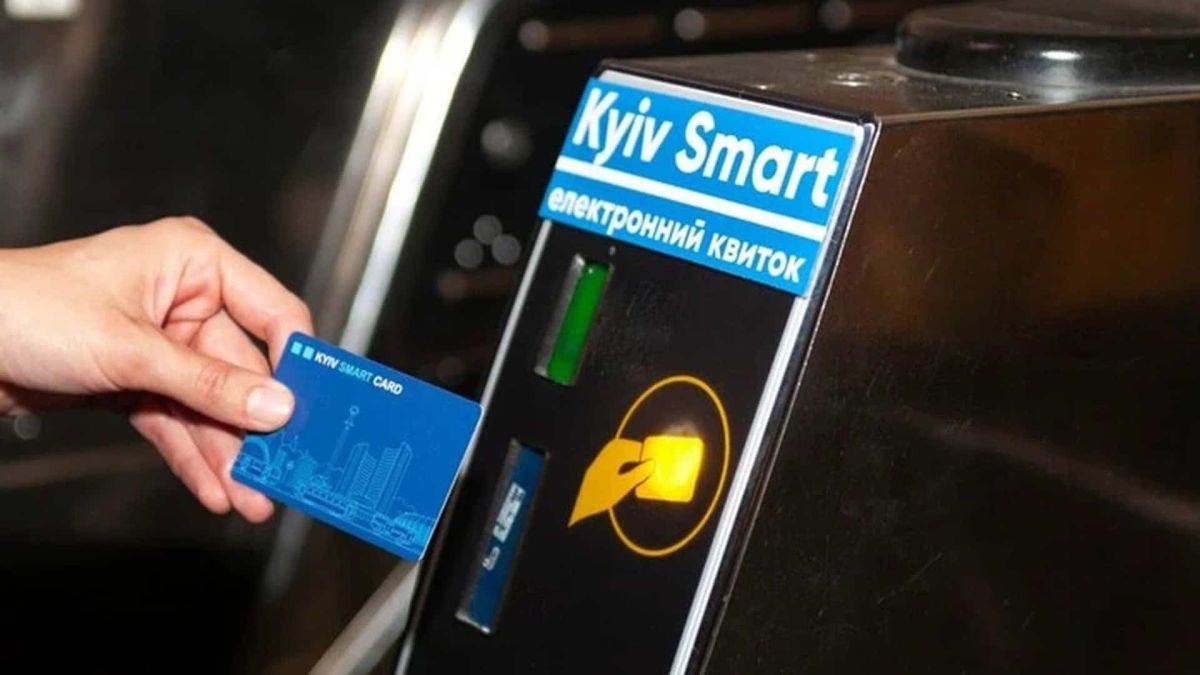 Пасажир прикладає транспортну картку до валідатора електронного квитка на турнікеті київського метро