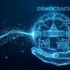 Головні новини Києва | Kyiv.News Рука тримає голограму з написом Democracy, символами парламенту, терезів правосуддя та голосування