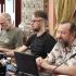 Головні новини Києва | Kyiv.News Троє науковців за столом під час пресконференції у Софії Київській, серед них В'ячеслав Корнієнко, перед ними мікрофони й ноутбук