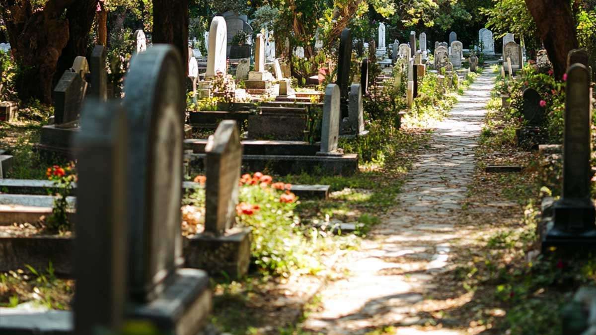 a stone path with tombstones in a cemetery