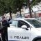 Двоє озброєних поліцейських спецпризначенців полку поліції №1 біля службового автомобіля після повернення до служби