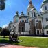 Софійський собор у Києві із золотими та зеленими банями, біле мурування й зелений газон з відвідувачами у сонячний день