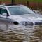 Головні новини Києва | Kyiv.News Легковий автомобіль частково затоплений водою під час сильної зливи — ілюстрація до наслідків негоди для транспорту в Києві 3 липня 2026 року